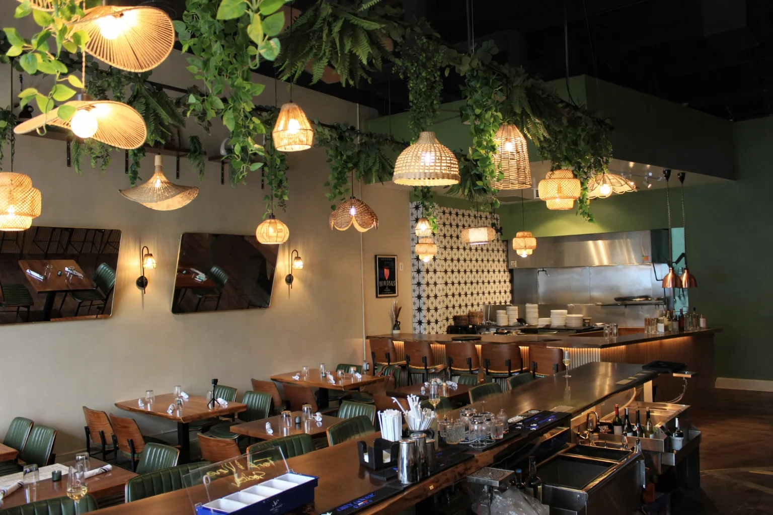 Stylish restaurant interior with hanging lights and greenery