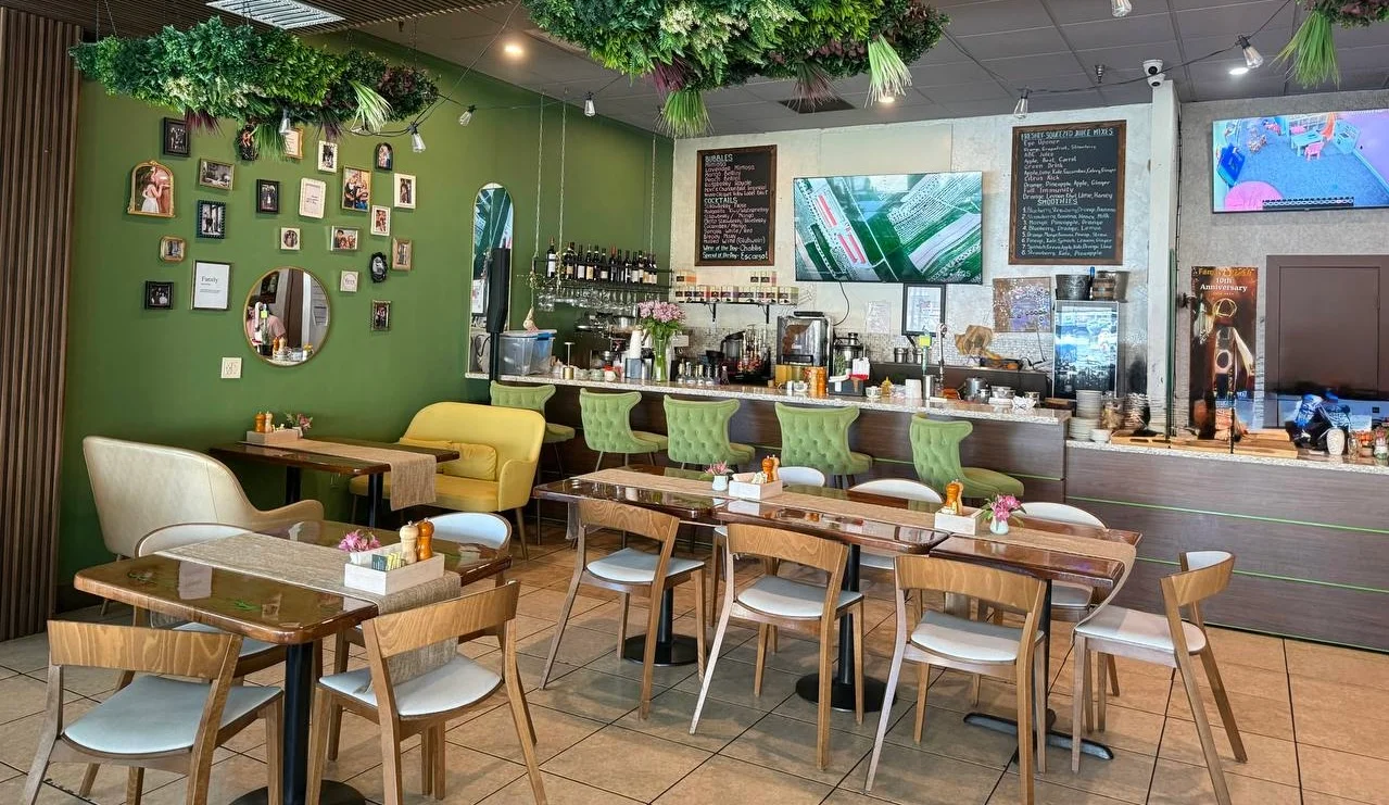 Charming restaurant interior with green accents and cozy seating