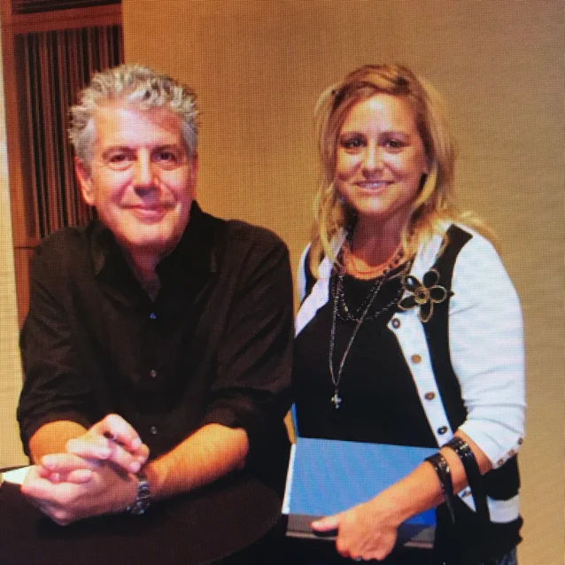 Two people posing together at an event
