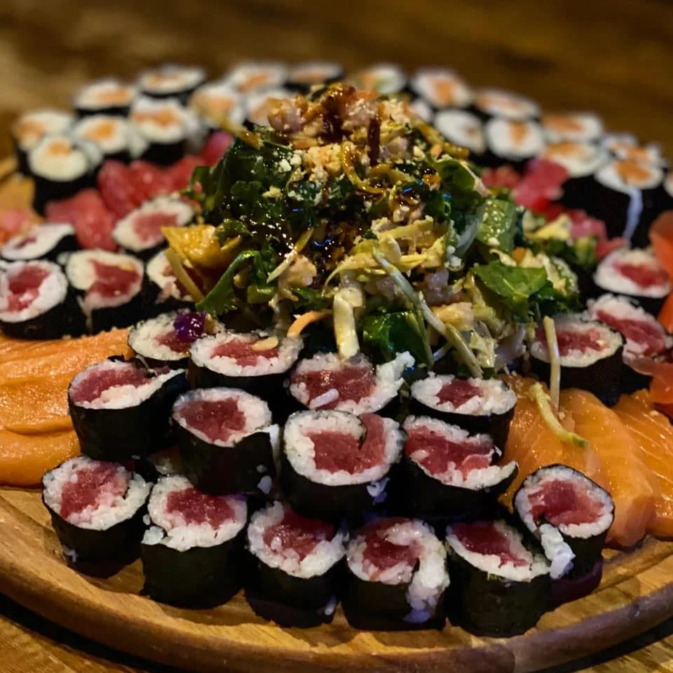Assorted sushi platter featuring rolls and sashimi