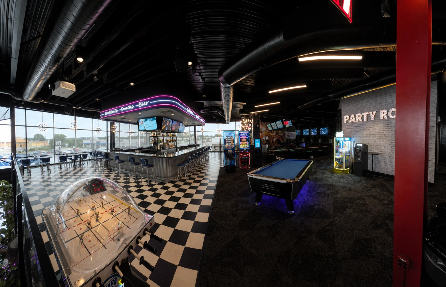 Modern restaurant interior with bar and arcade games