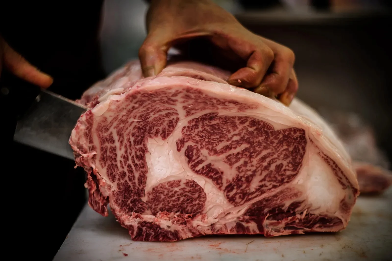 Butcher preparing marbled Wagyu beef