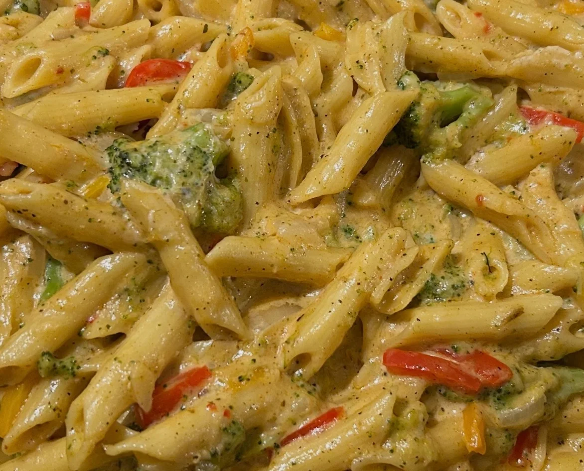 Creamy penne pasta primavera with vegetables