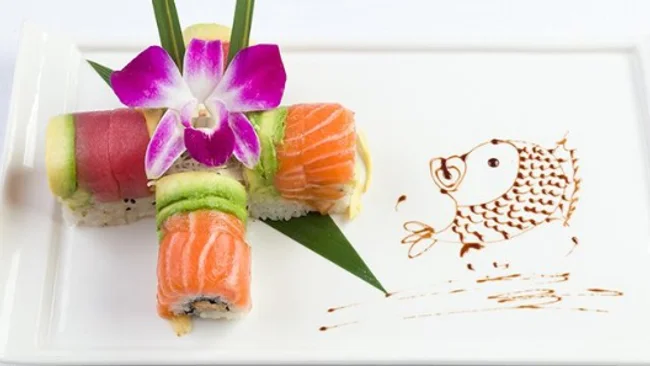 Colorful sushi platter with orchid garnish