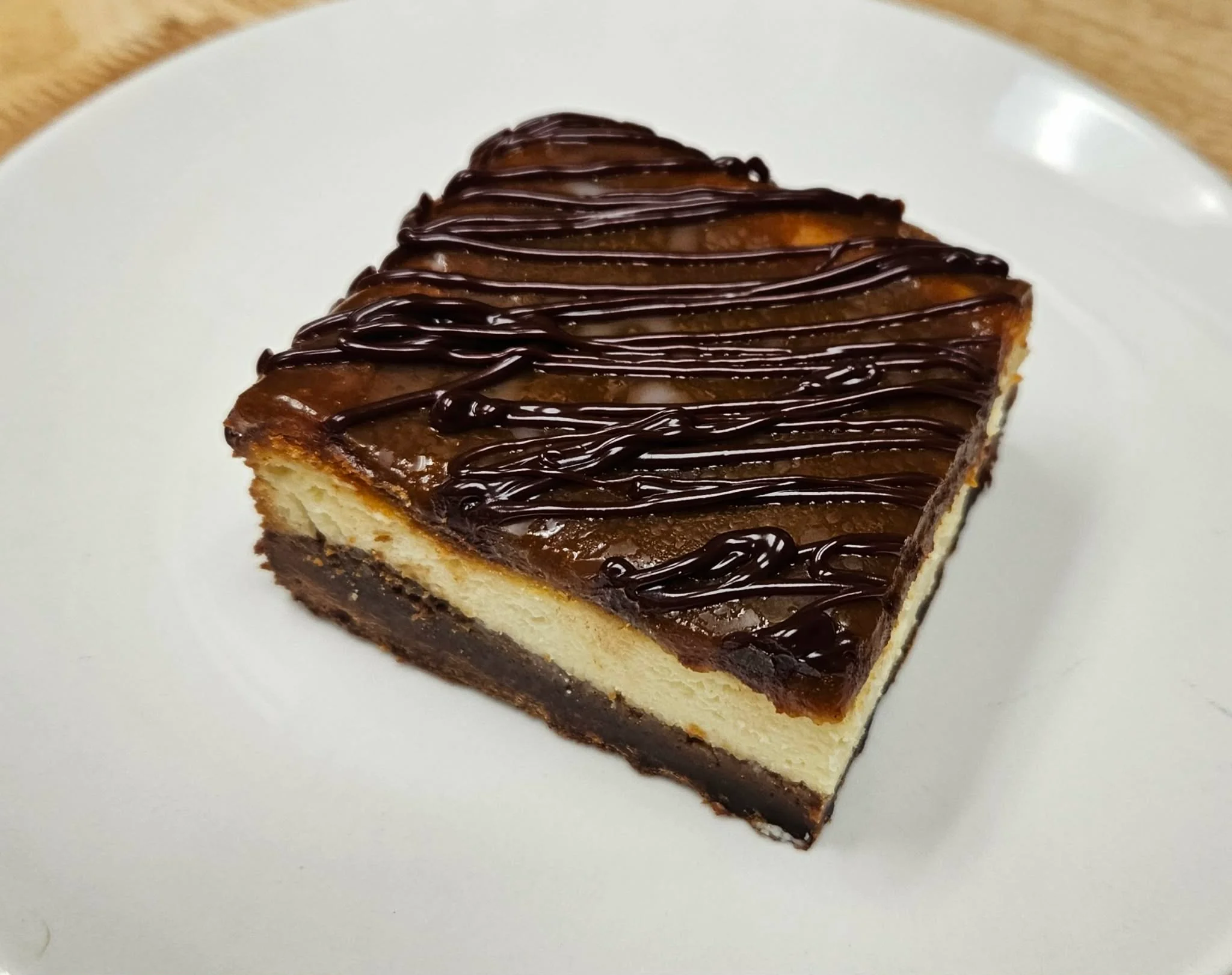 Vanilla Caramel Brownie Cheesecake Bar with Chocolate drizzle