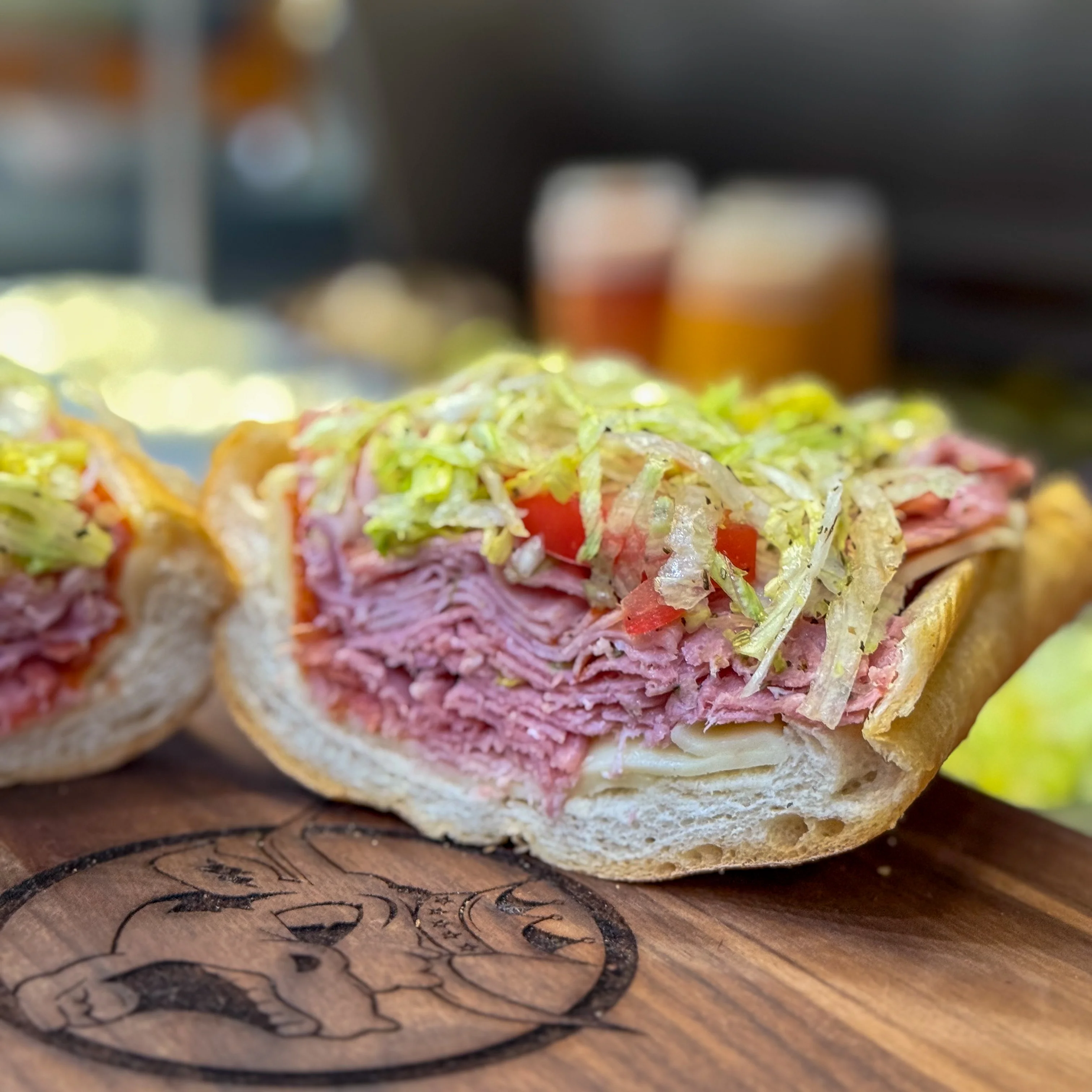  Cold sub sandwich with deli meat, shredded lettuce, and tomato.