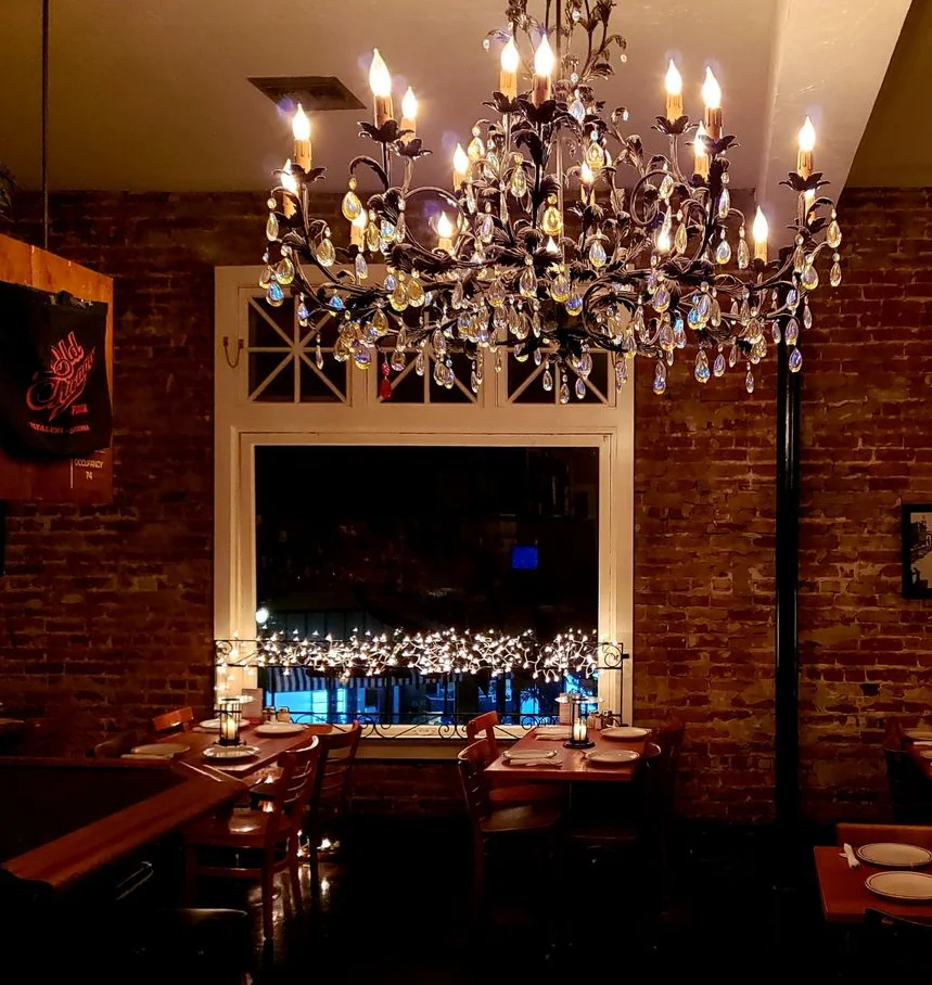 Cozy restaurant interior with elegant chandelier and warm ambiance
