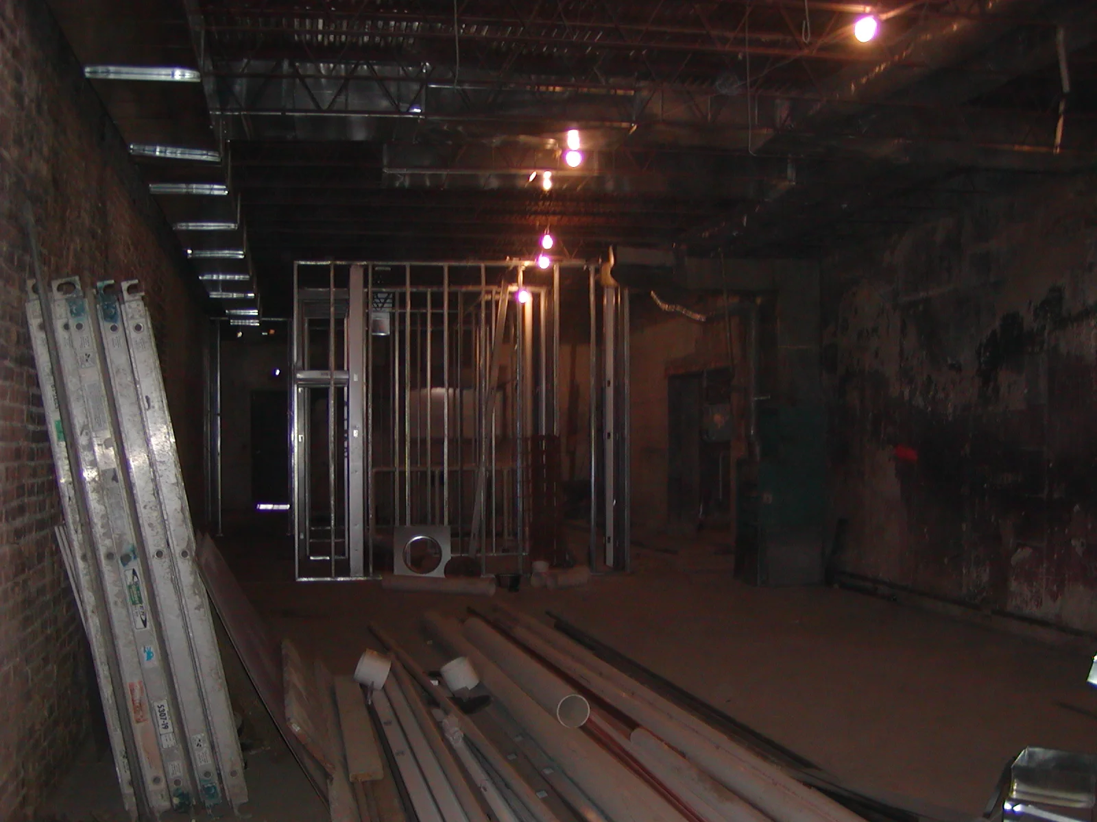 Construction site interior with exposed brick and metal framing