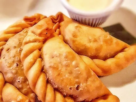 Crispy Argentine empanadas served with dipping sauce