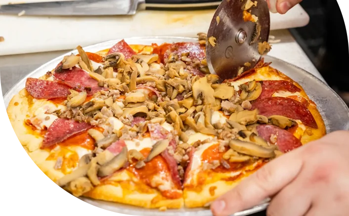 Freshly sliced pepperoni pizza with mushrooms