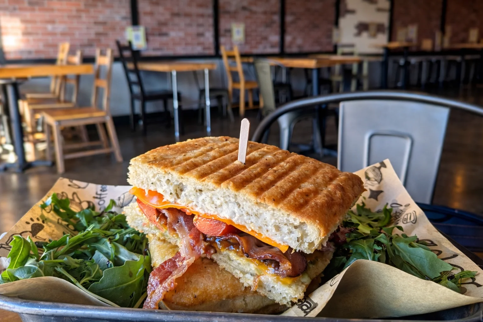 A variety of delicious paninis displayed on a wooden board.