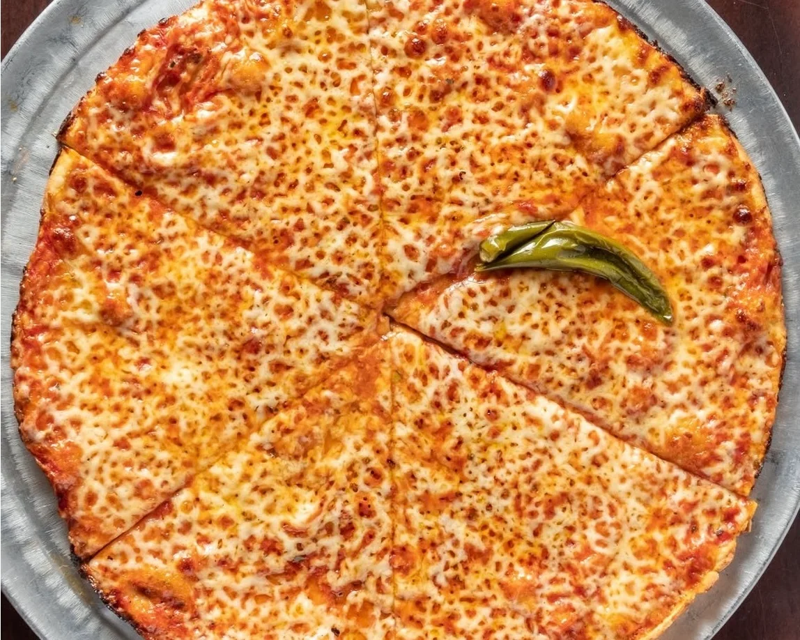 Cheese pizza with golden crust and green pepper garnish