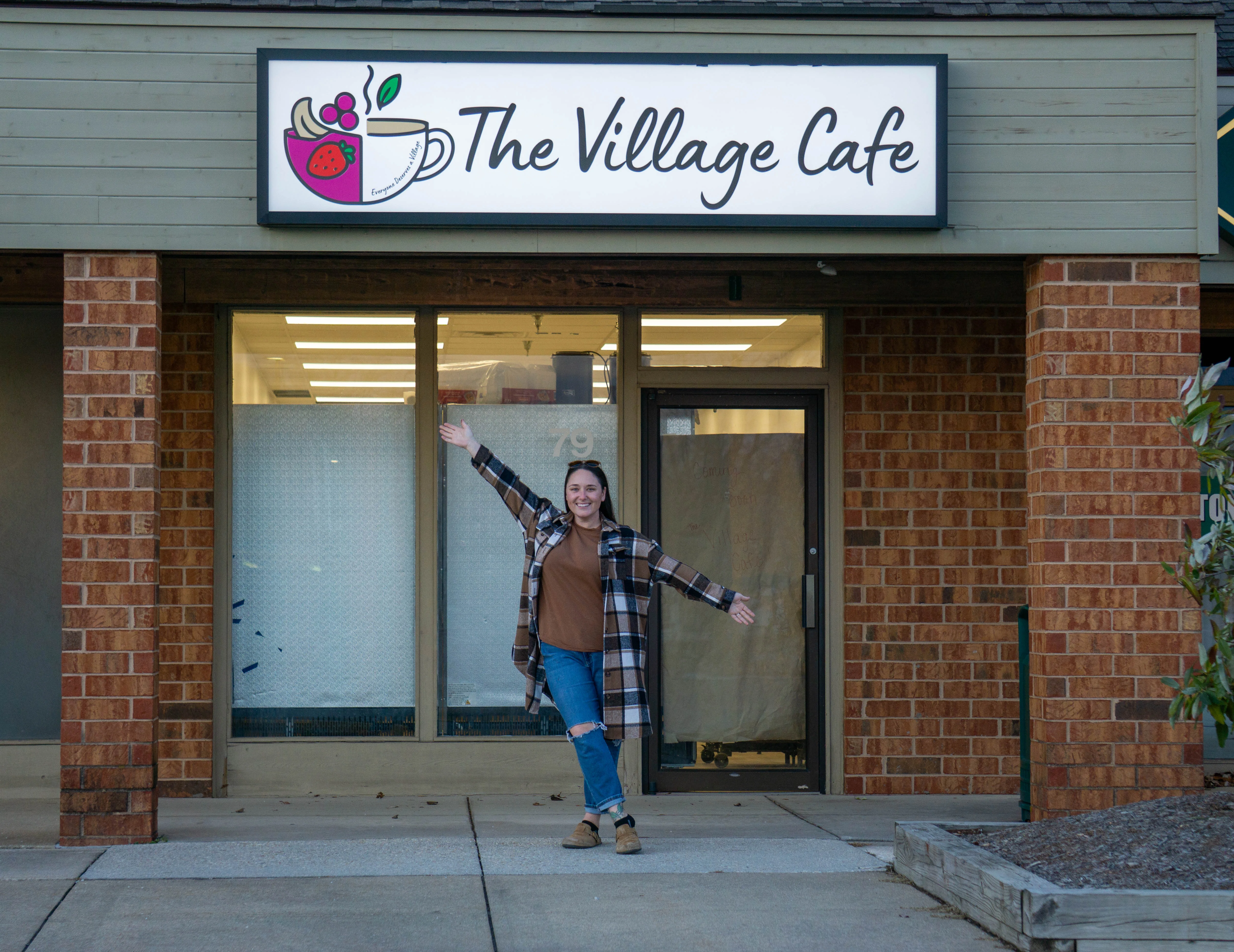 Owner welcoming guests to The Village Cafe entrance