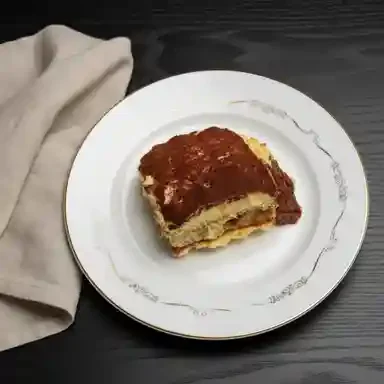 Classic Italian tiramisu dessert on a white plate