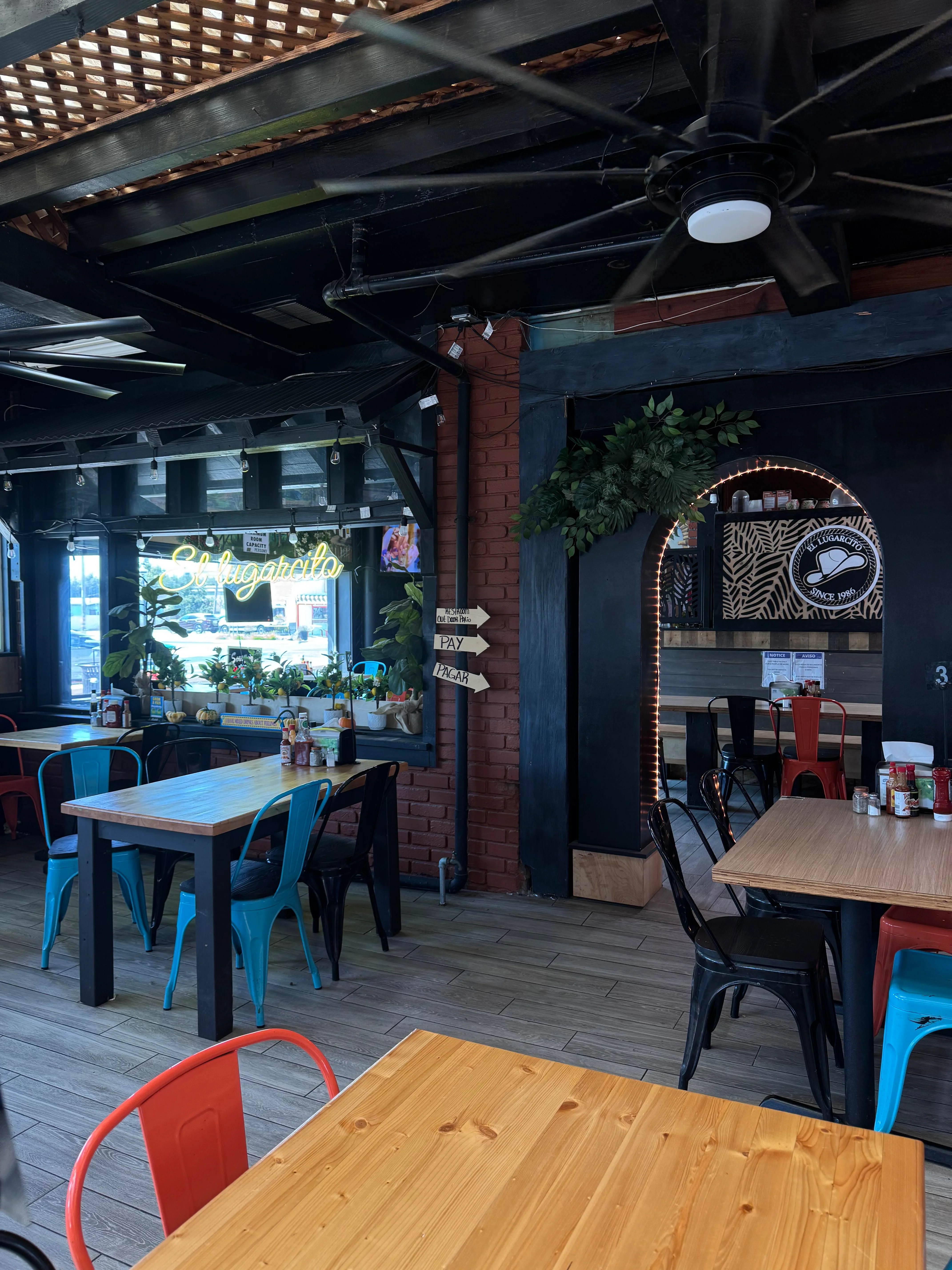 Cozy restaurant interior with colorful chairs and wooden tables