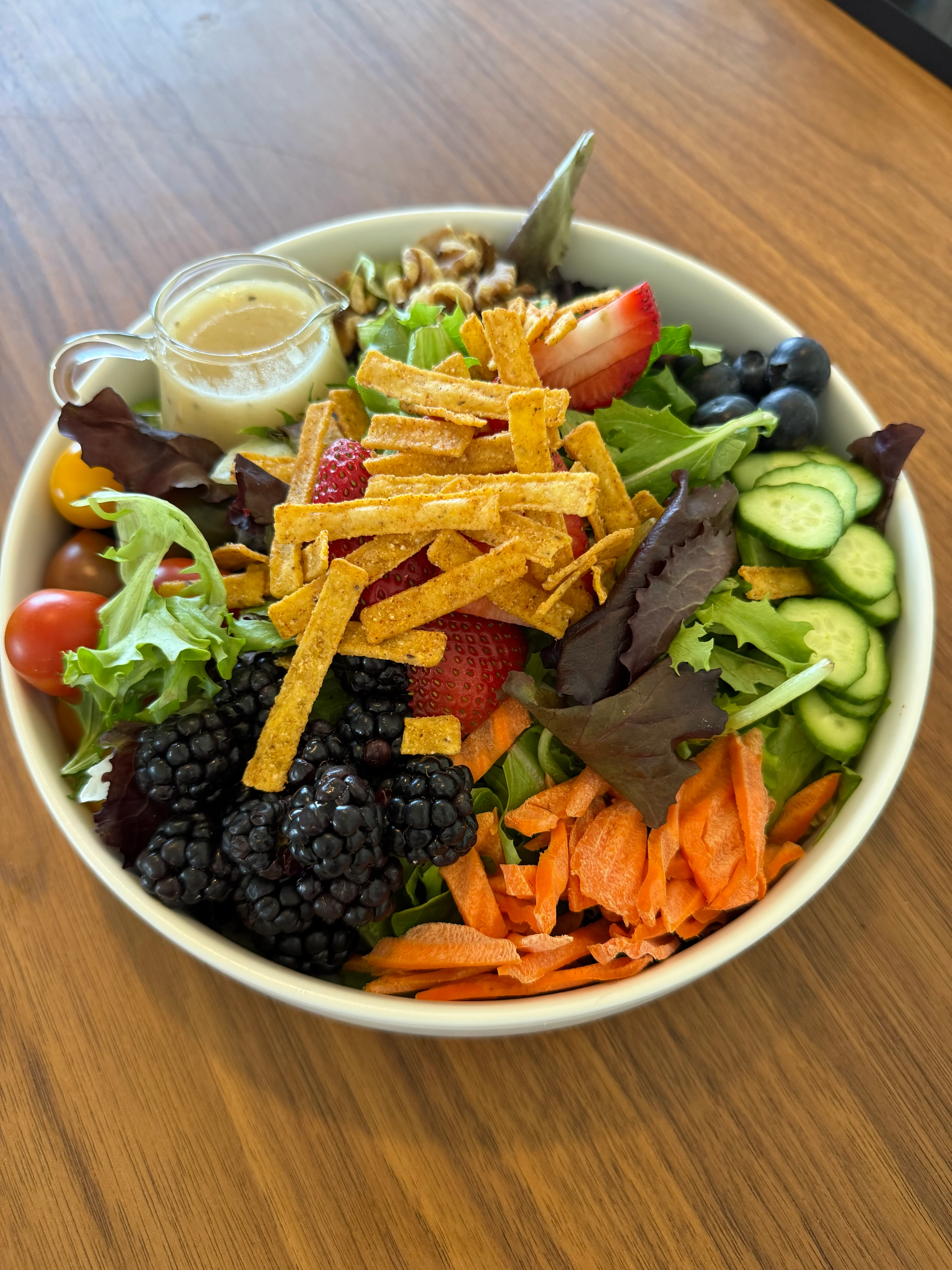 Vibrant garden salad with fresh fruits and crunchy toppings