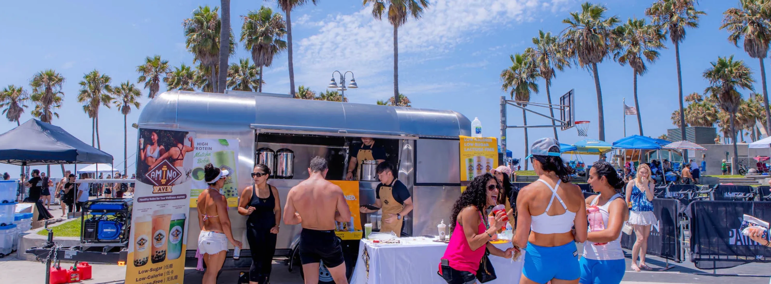 Food truck serving healthy boba drinks at a beach event