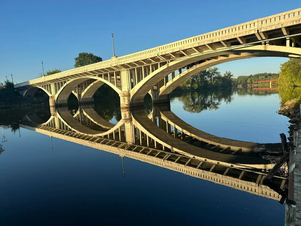 Historic bridge reflecting in calm water
