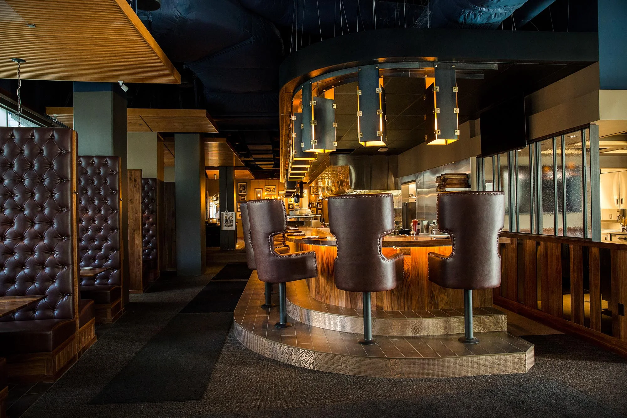 Stylish restaurant interior with leather chairs and a modern bar.