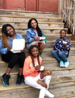 Group of friends enjoying takeout on wooden steps