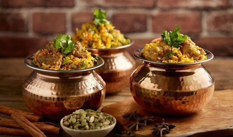 Authentic Indian biryani served in traditional copper pots