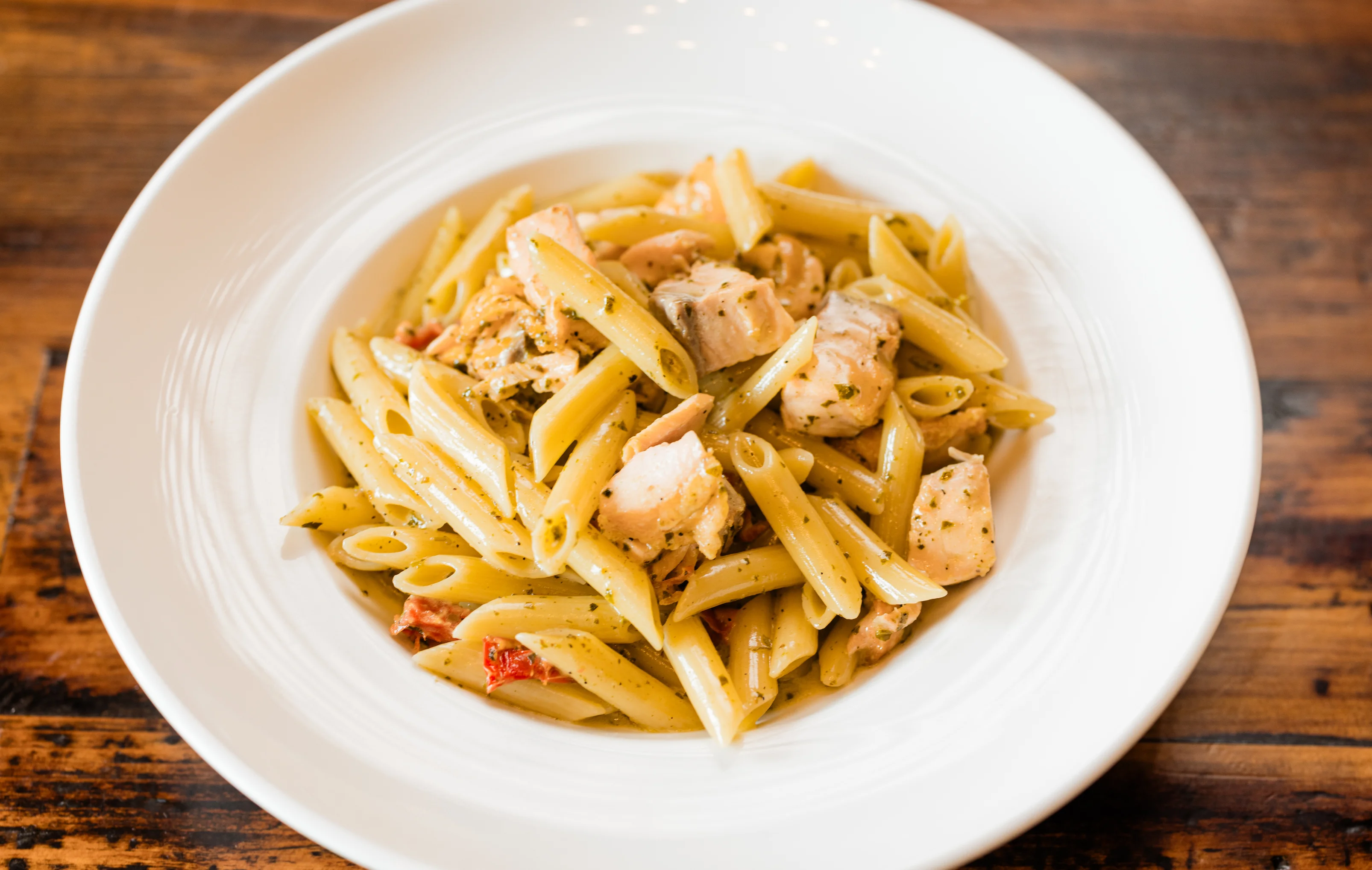 Penne pasta with pesto and grilled chicken
