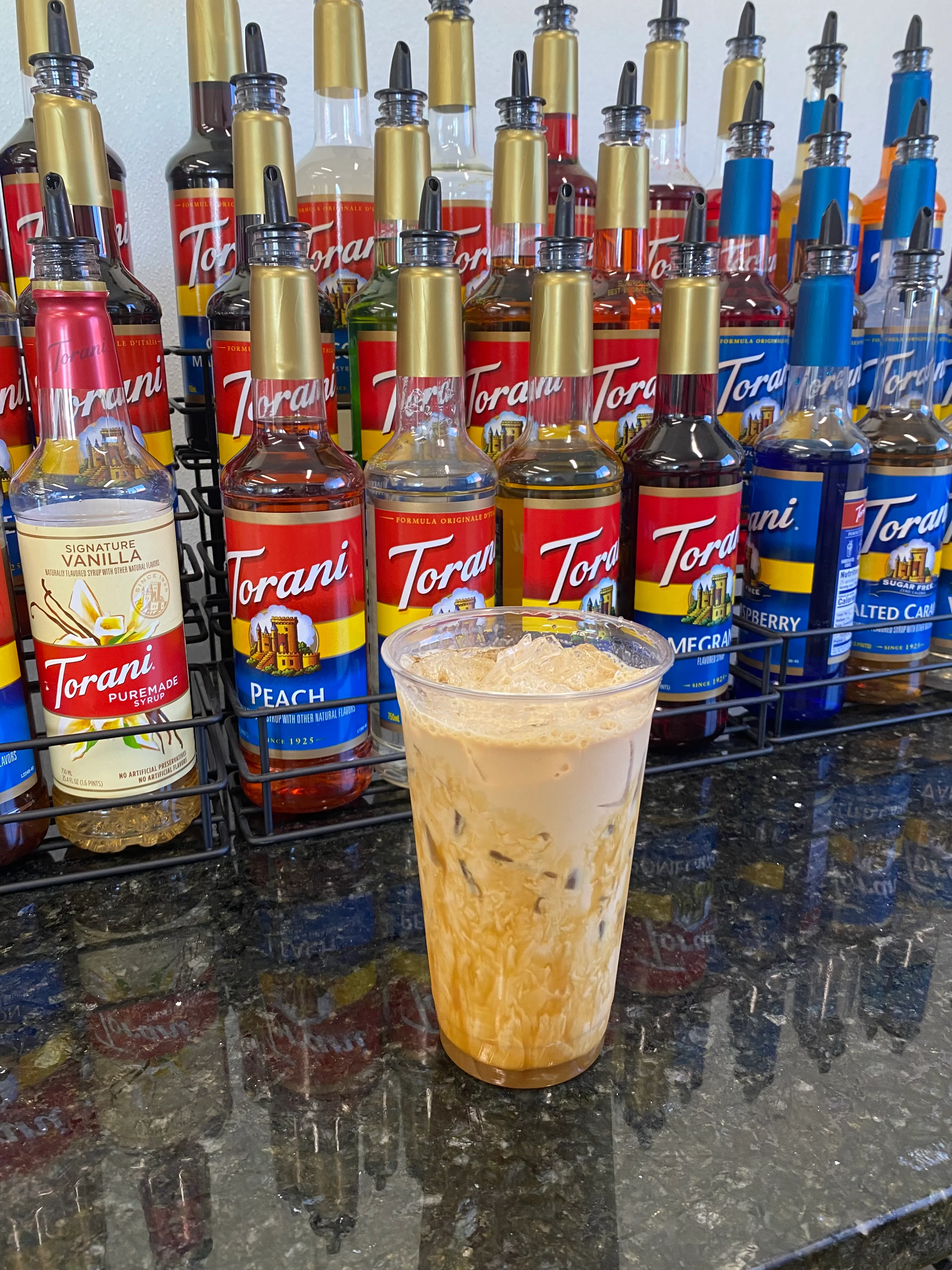 Iced coffee drink with flavored syrups in a cafe setting