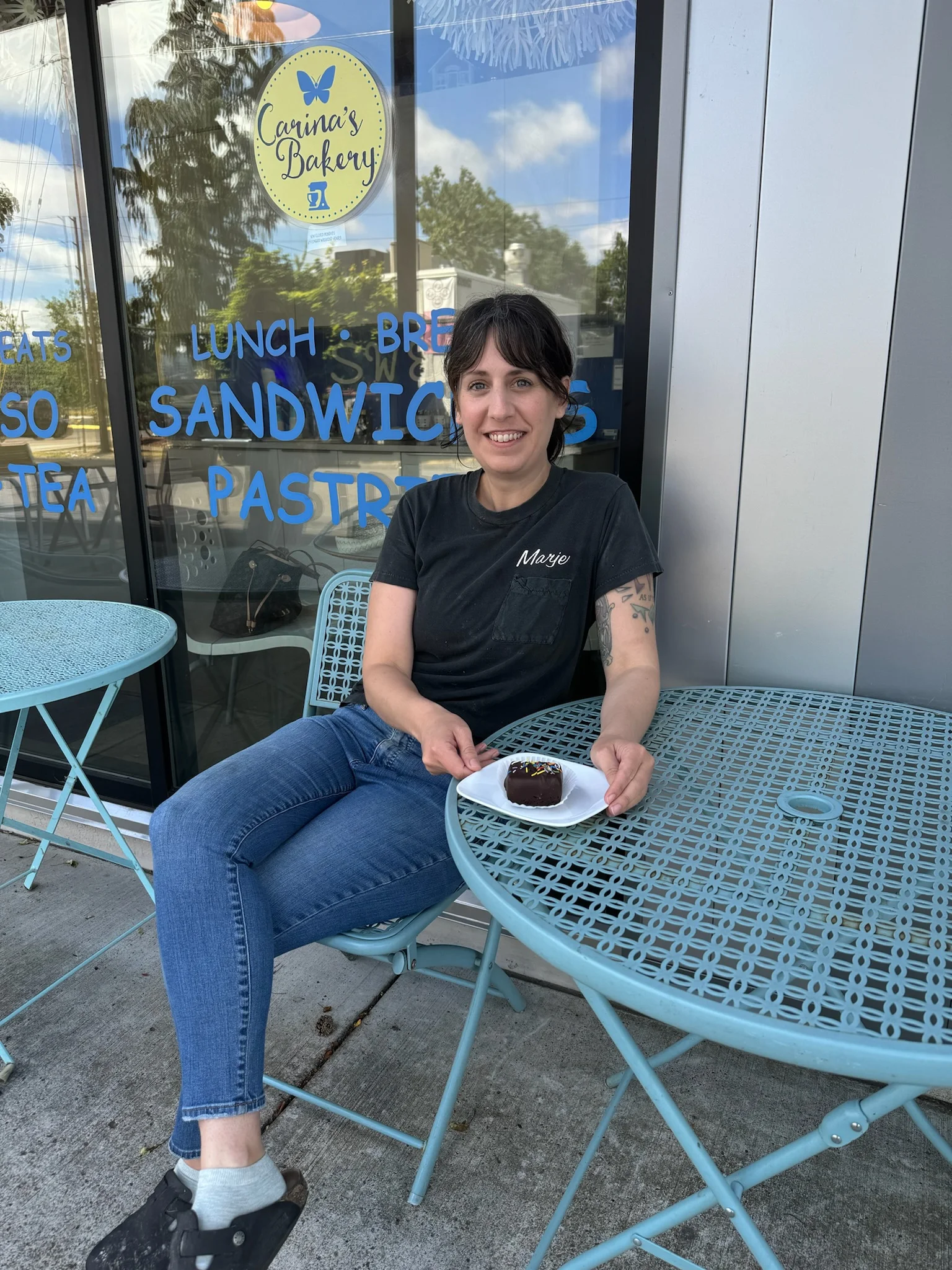 Person enjoying a chocolate dessert at a bakery