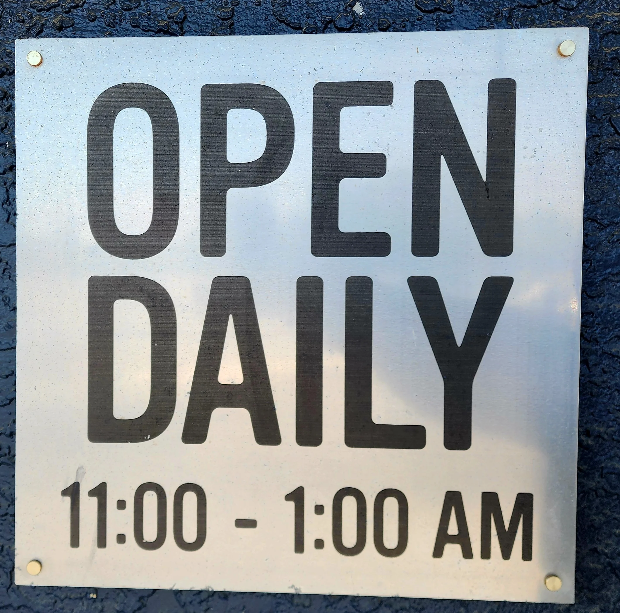 Restaurant sign indicating open hours daily from 11:00 AM to 1:00 AM