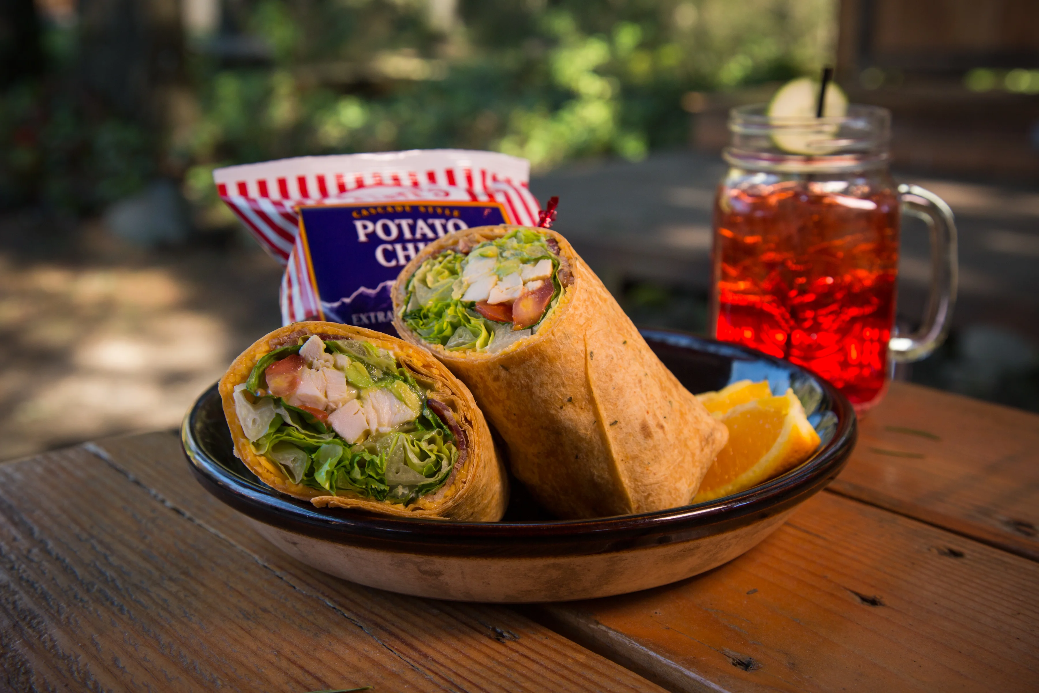 Grilled chicken wrap with fresh greens and chips