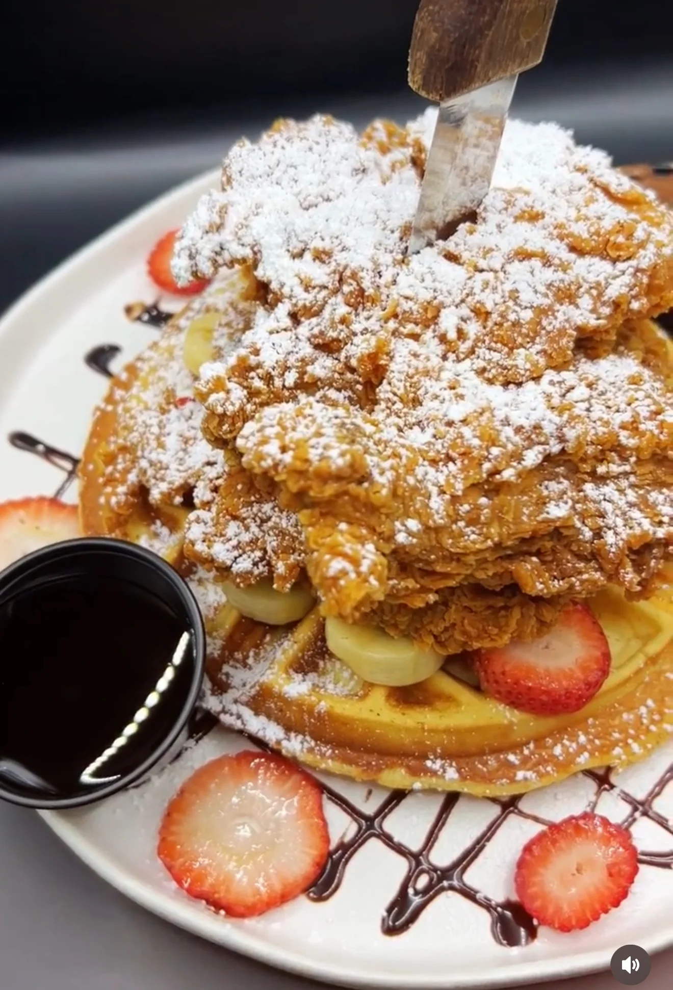 Southern chicken and waffles topped with powdered sugar