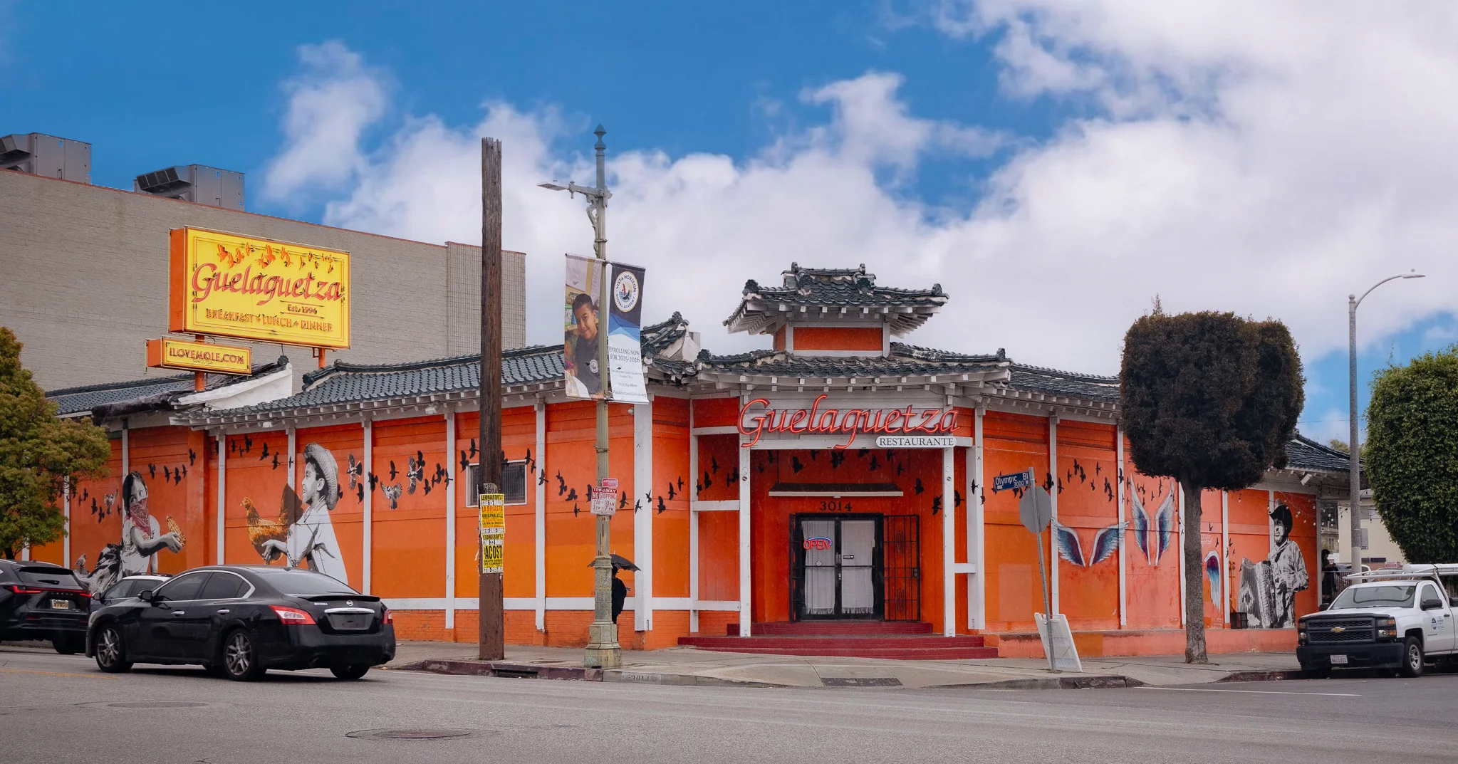 Colorful exterior of Guelaguetza restaurant with murals