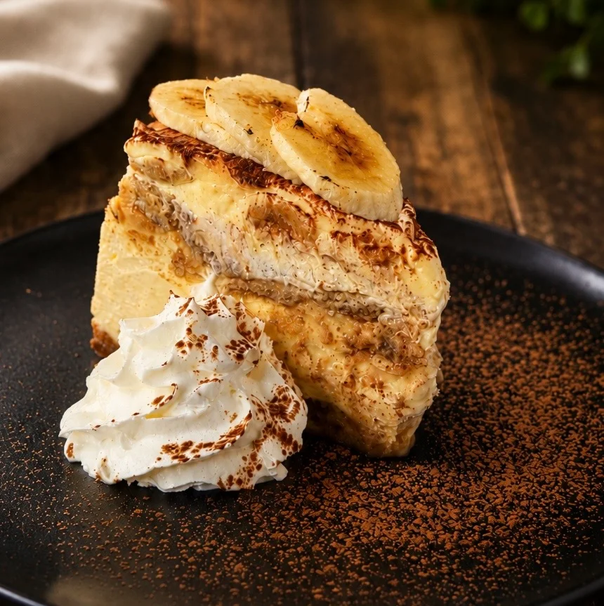 Slice of classic banana cream pie with whipped cream
