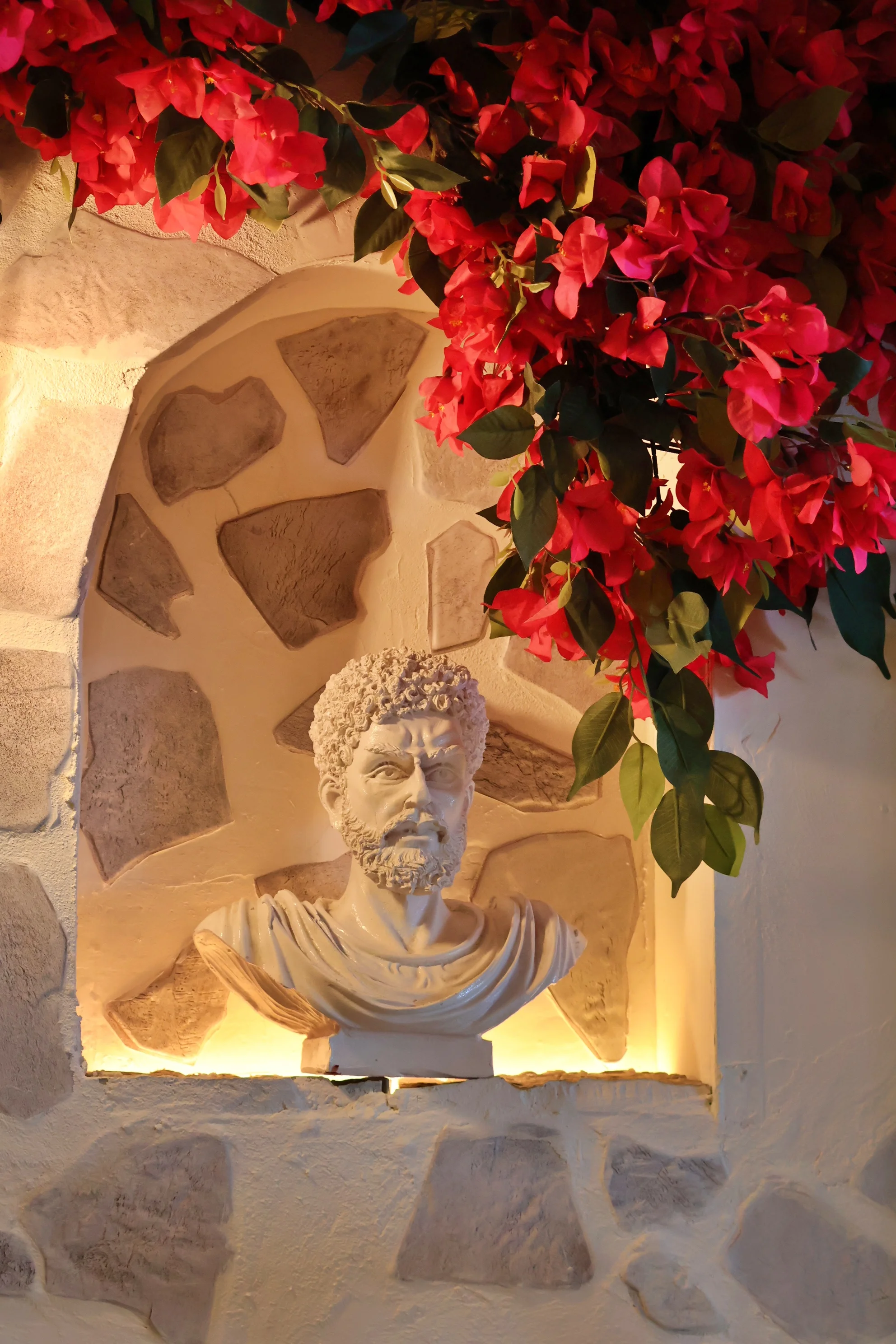 Bust of a historical figure surrounded by vibrant flowers