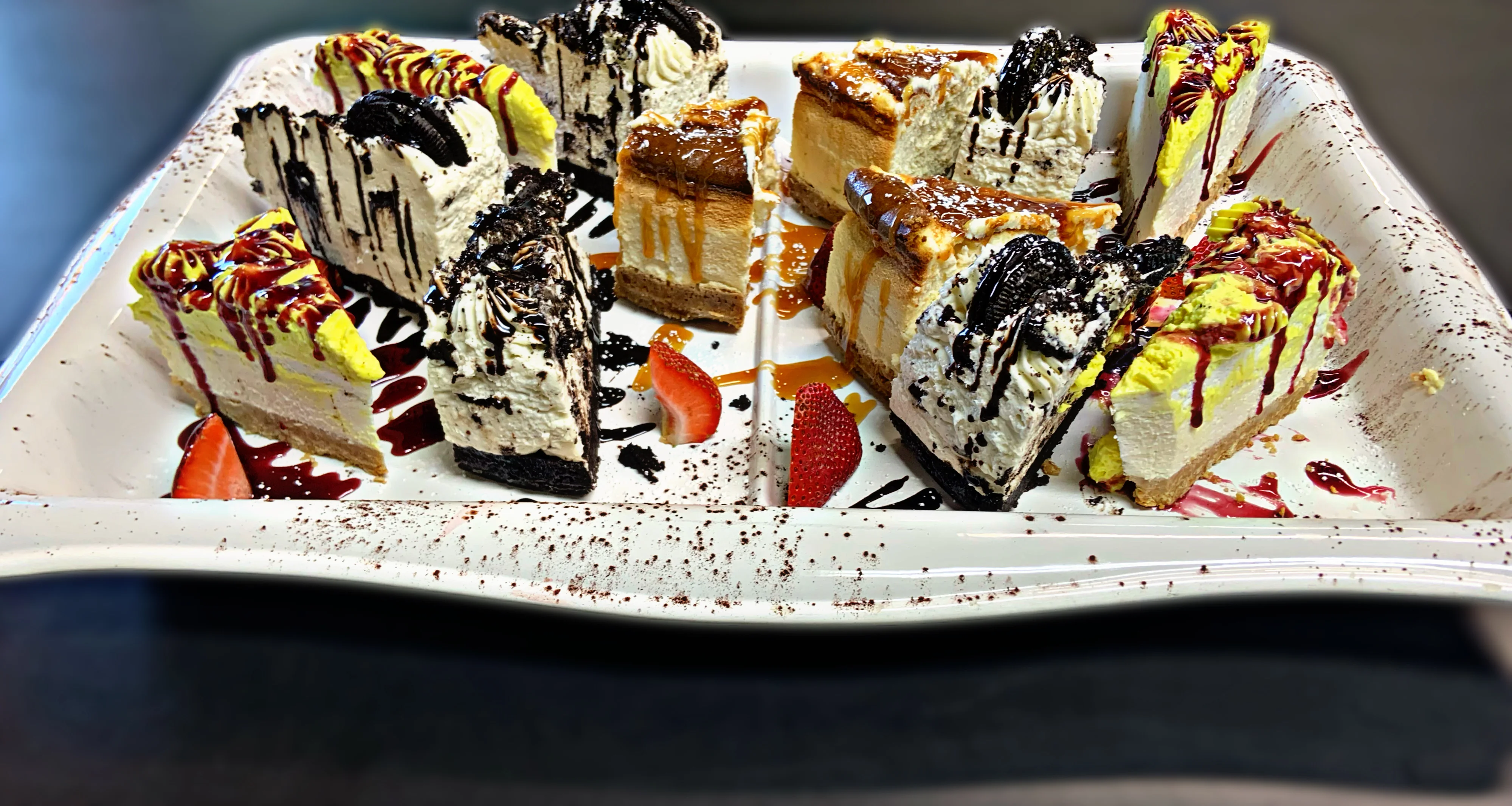 Assorted cheesecake slices on a decorative platter