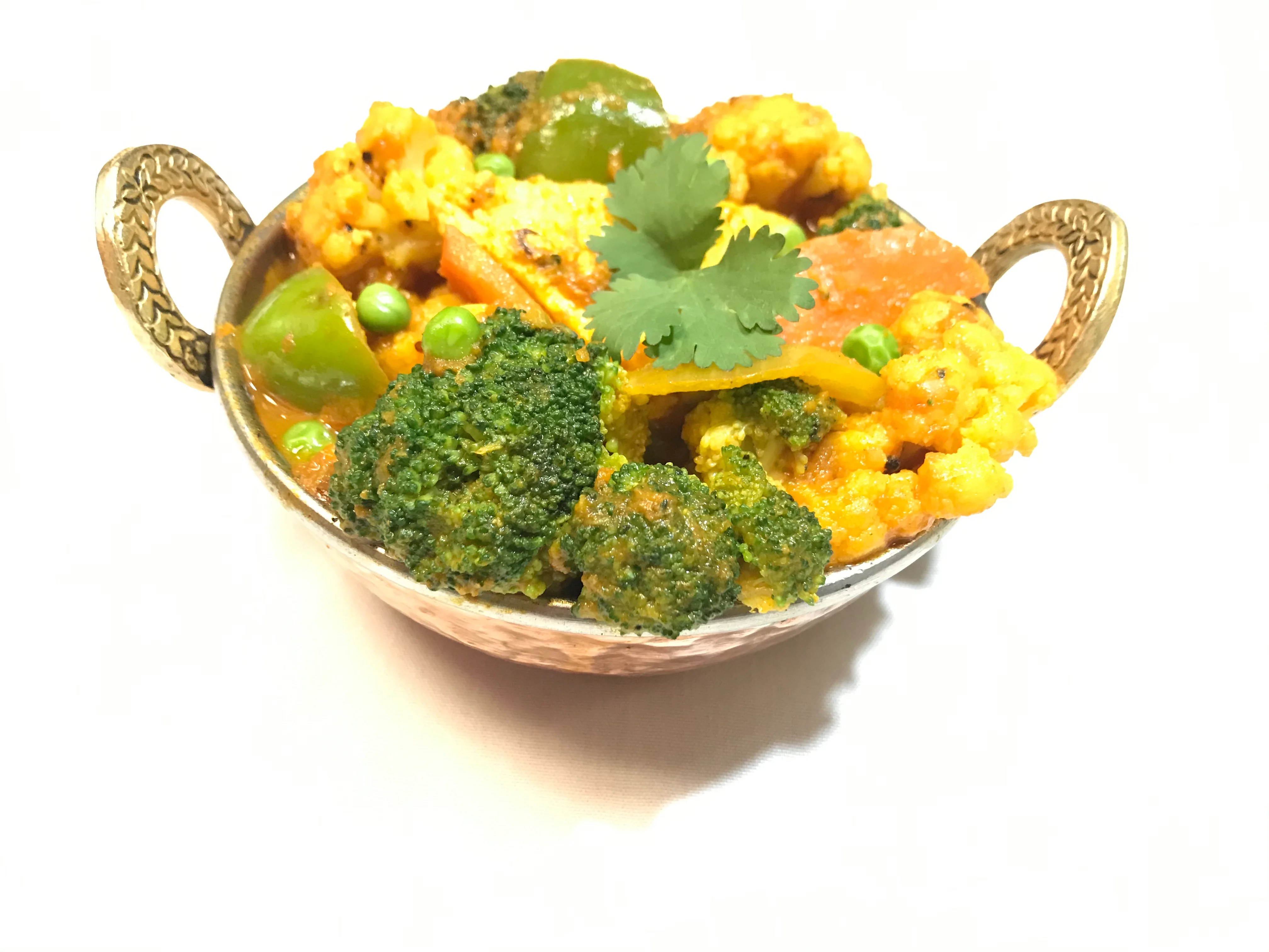 Vegetable curry in a traditional Indian serving bowl