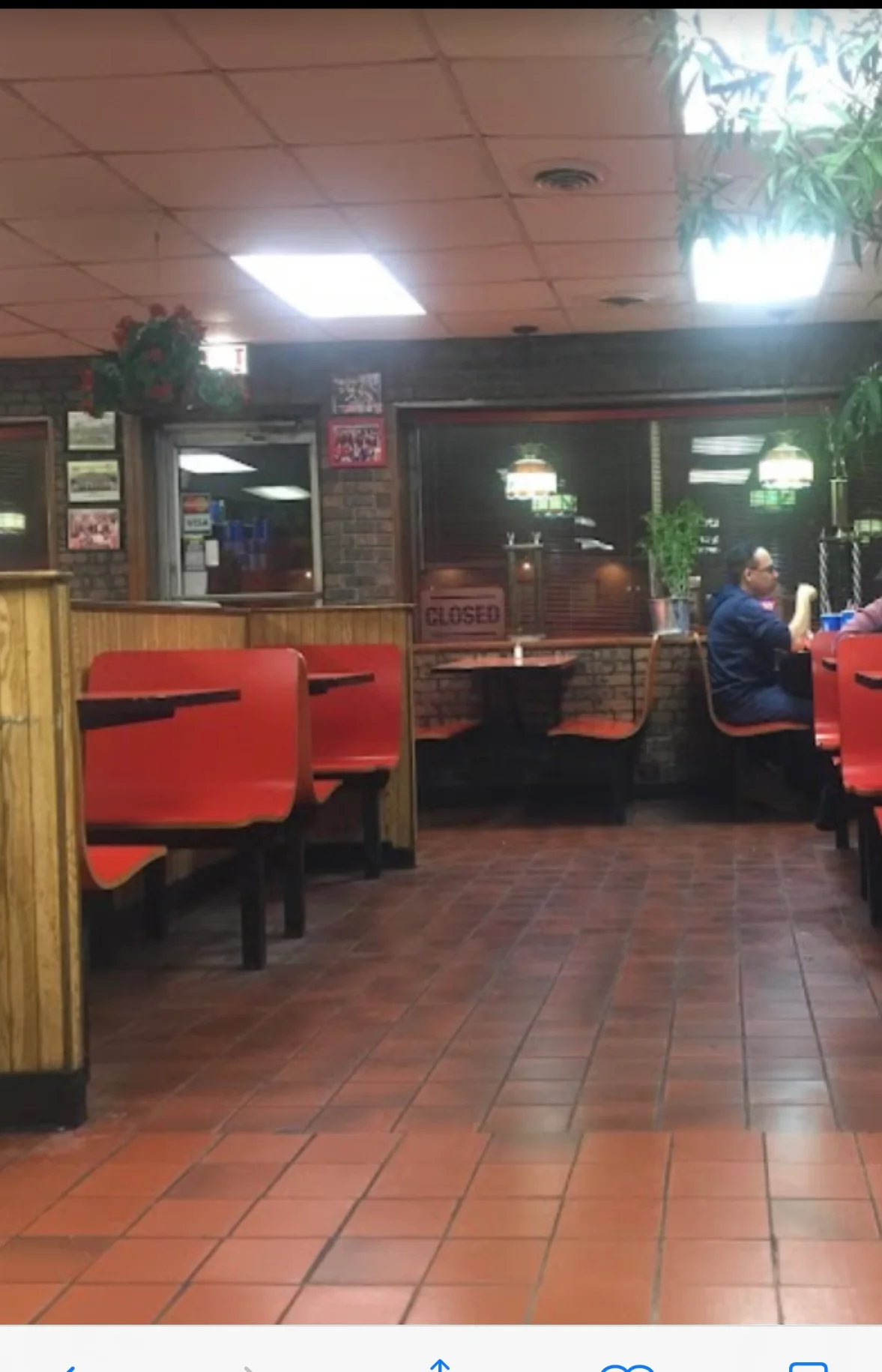 Cozy restaurant interior with red booths and warm lighting