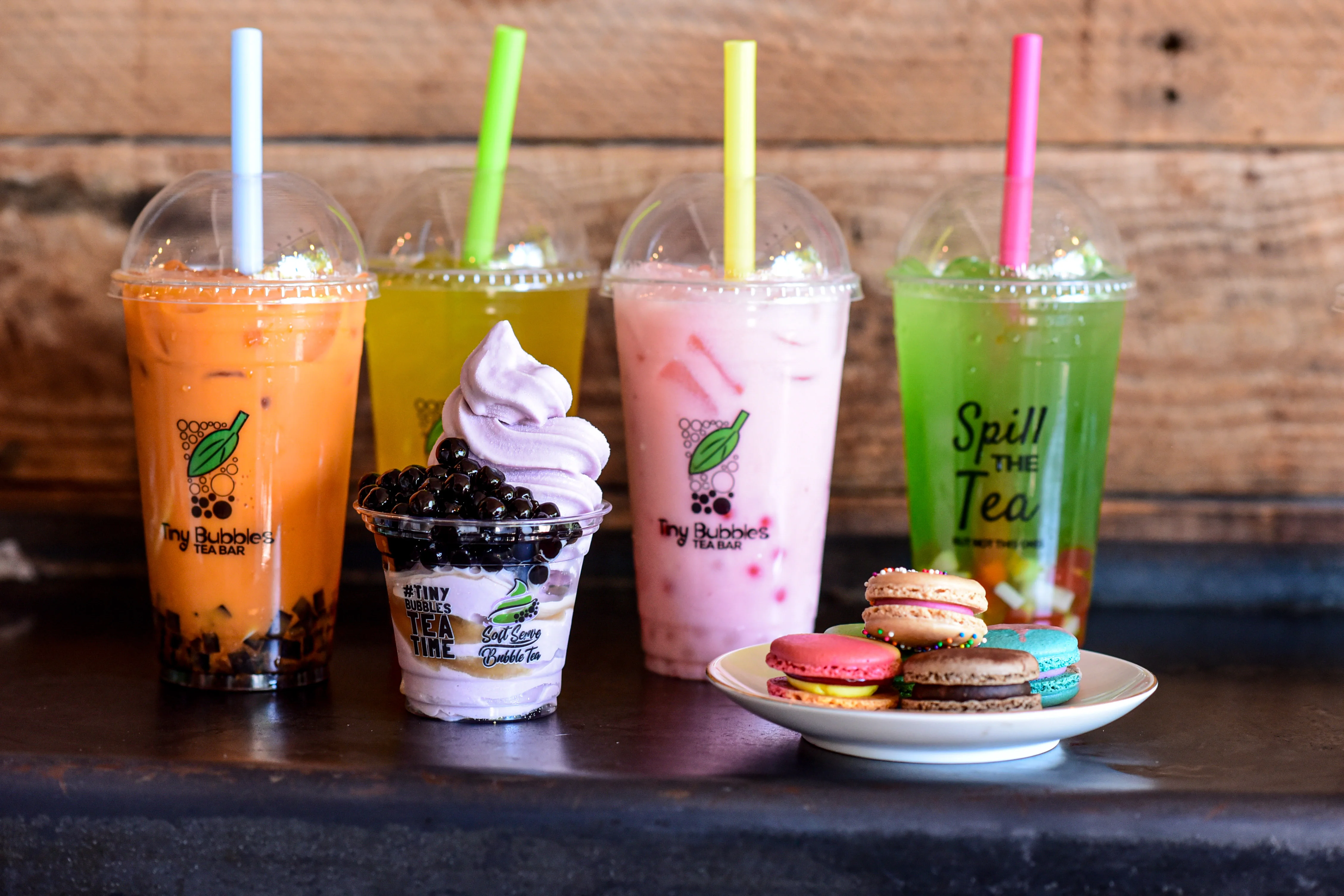 Refreshing iced beverages and colorful macarons on a rustic table