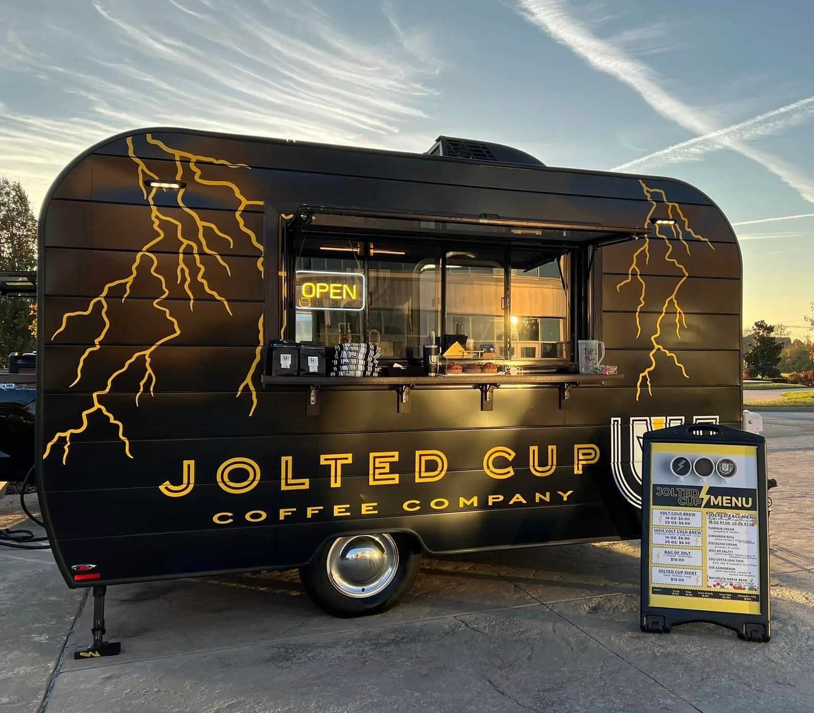 Coffee truck serving beverages in a vibrant outdoor setting