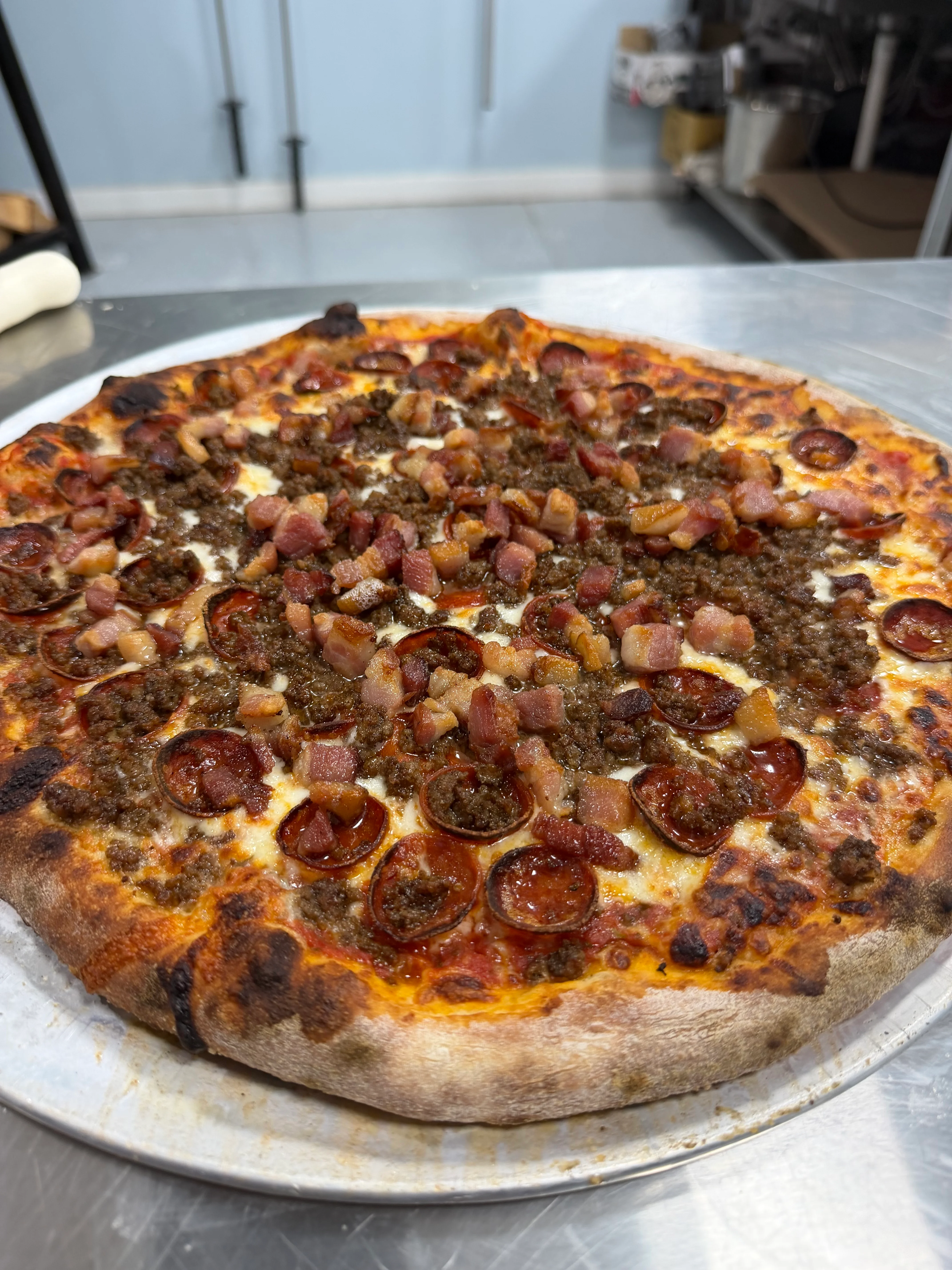 Loaded meat lover's pizza with pepperoni and bacon