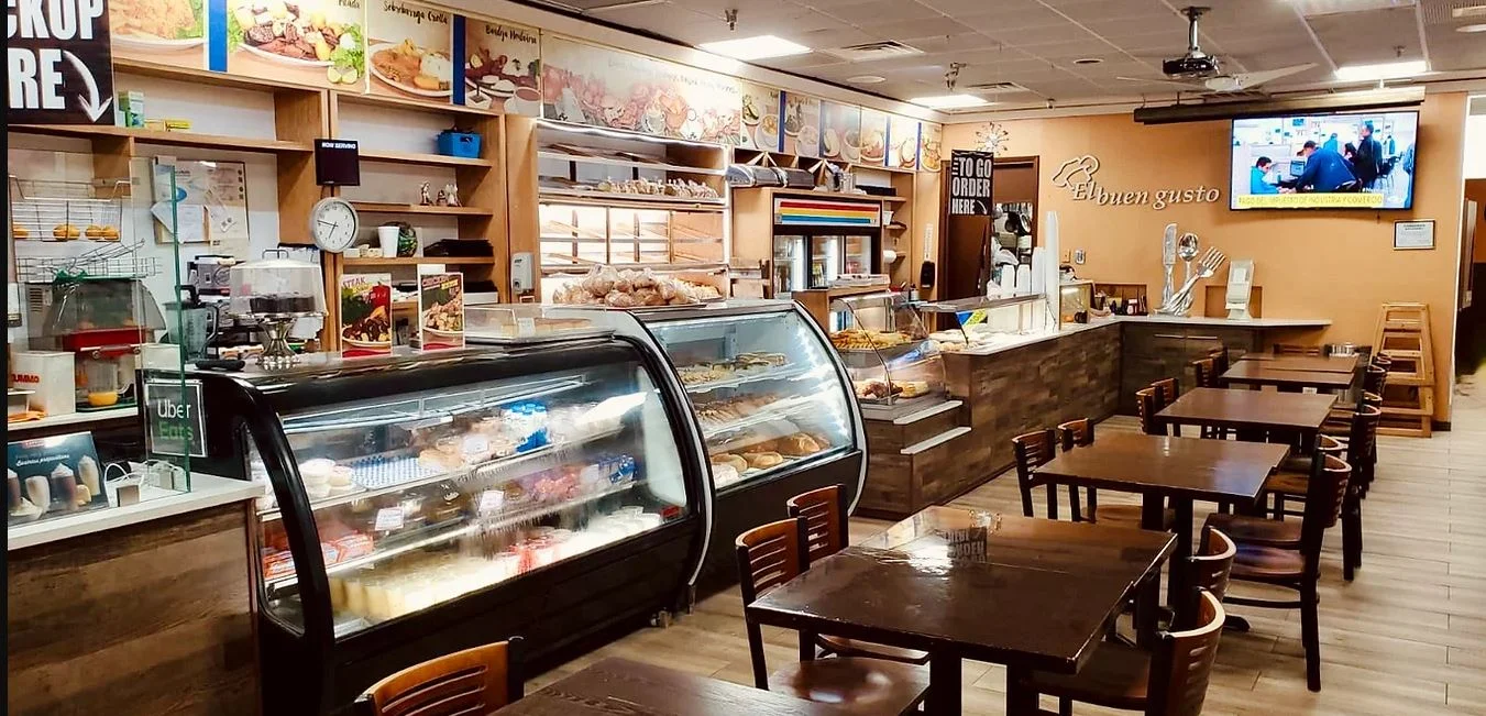 Cozy restaurant interior with display cases and wooden tables