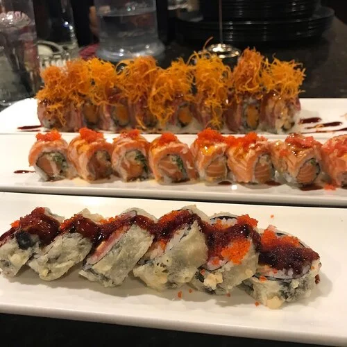 Assorted sushi rolls including tempura and spicy tuna