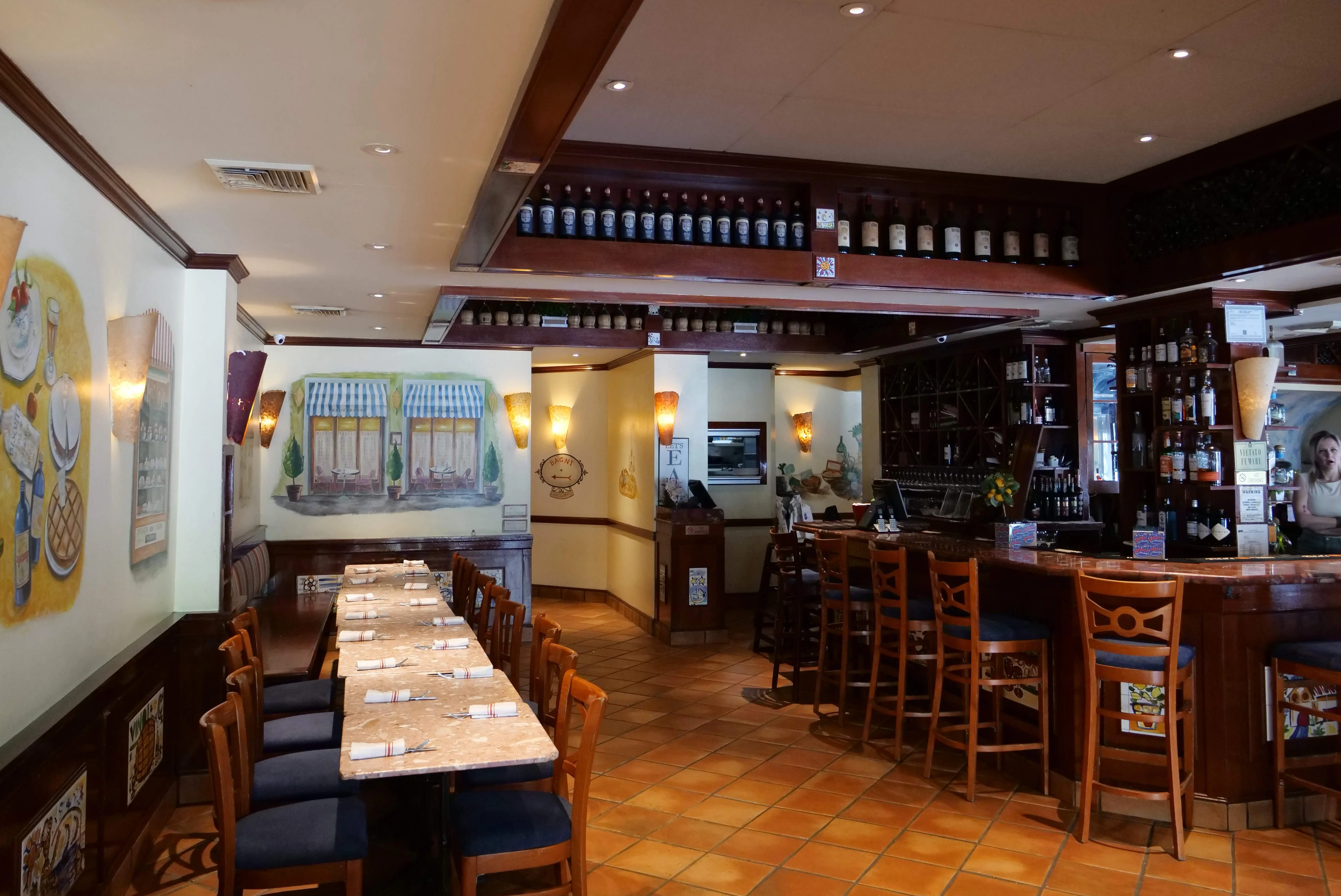 Cozy restaurant interior with wooden bar and artistic murals