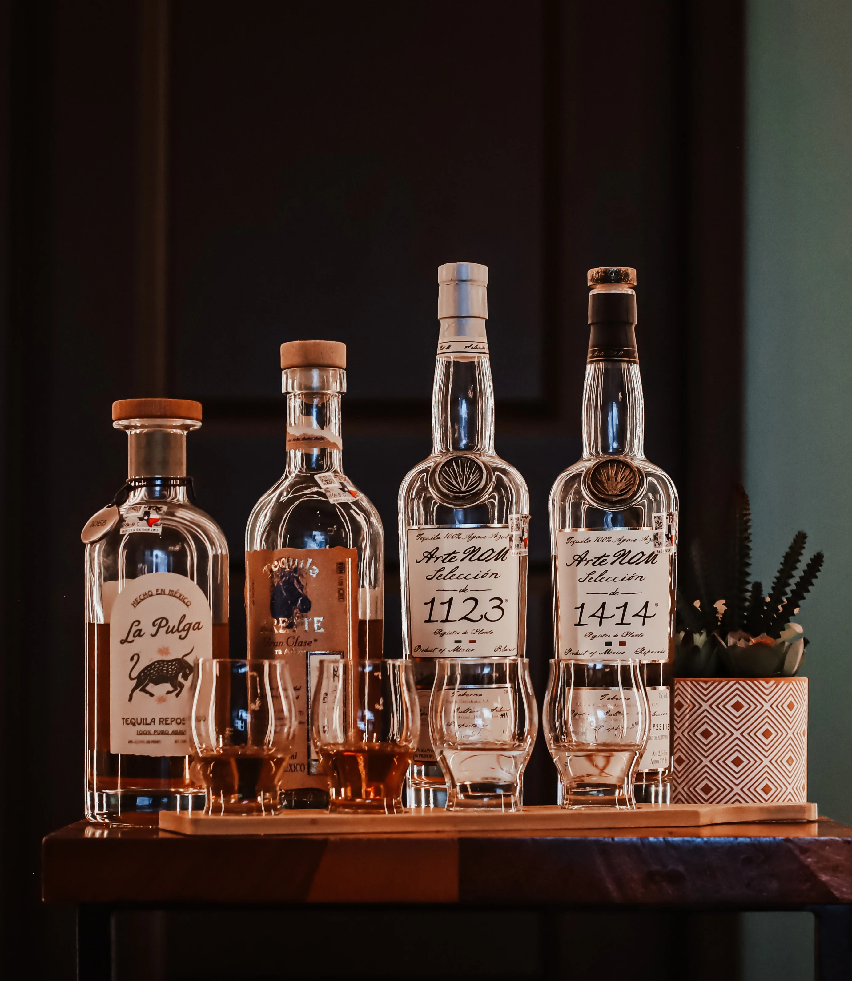Selection of premium tequila bottles on a wooden bar