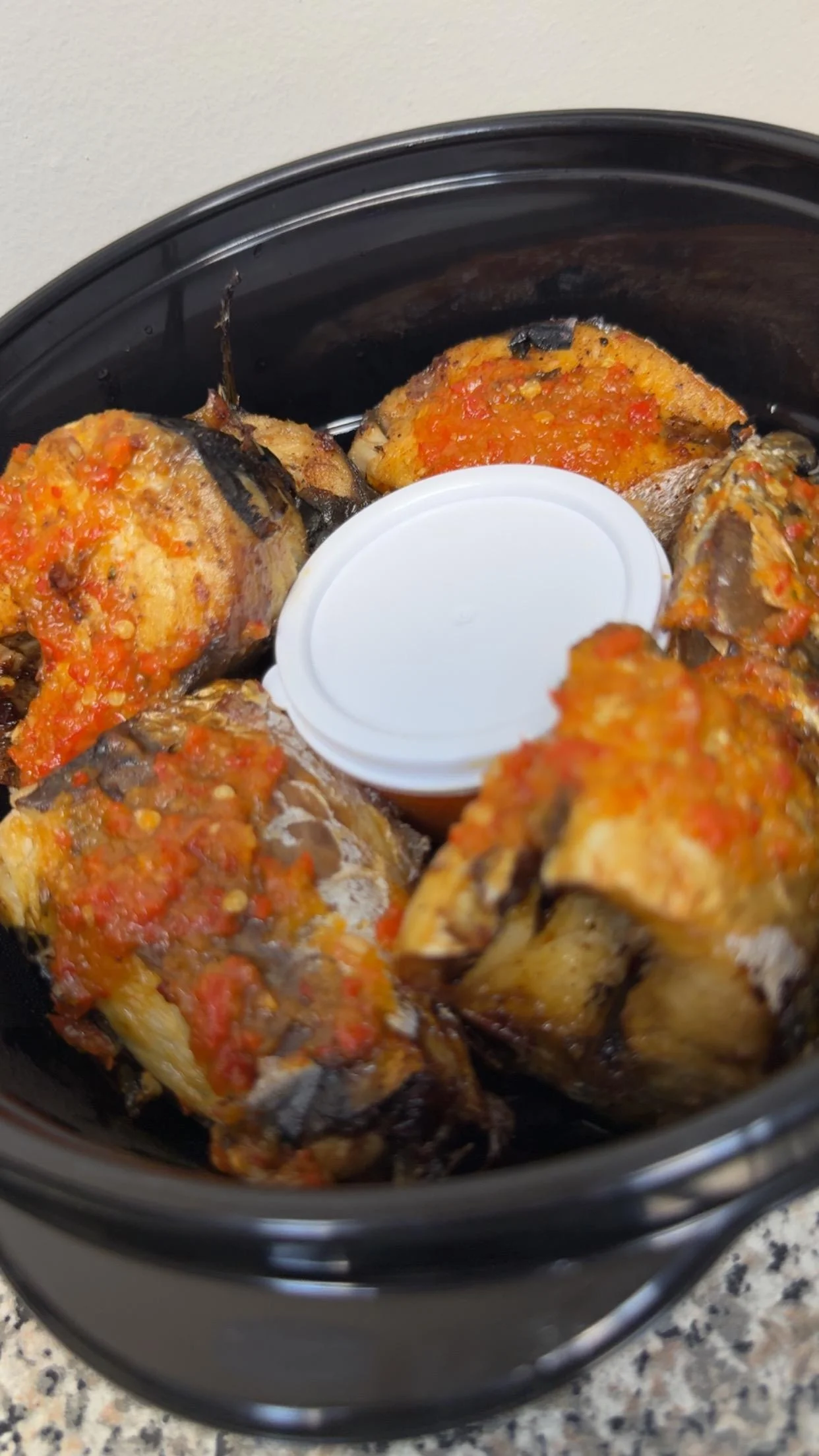 Grilled fish with spicy sauce, a popular West African dish