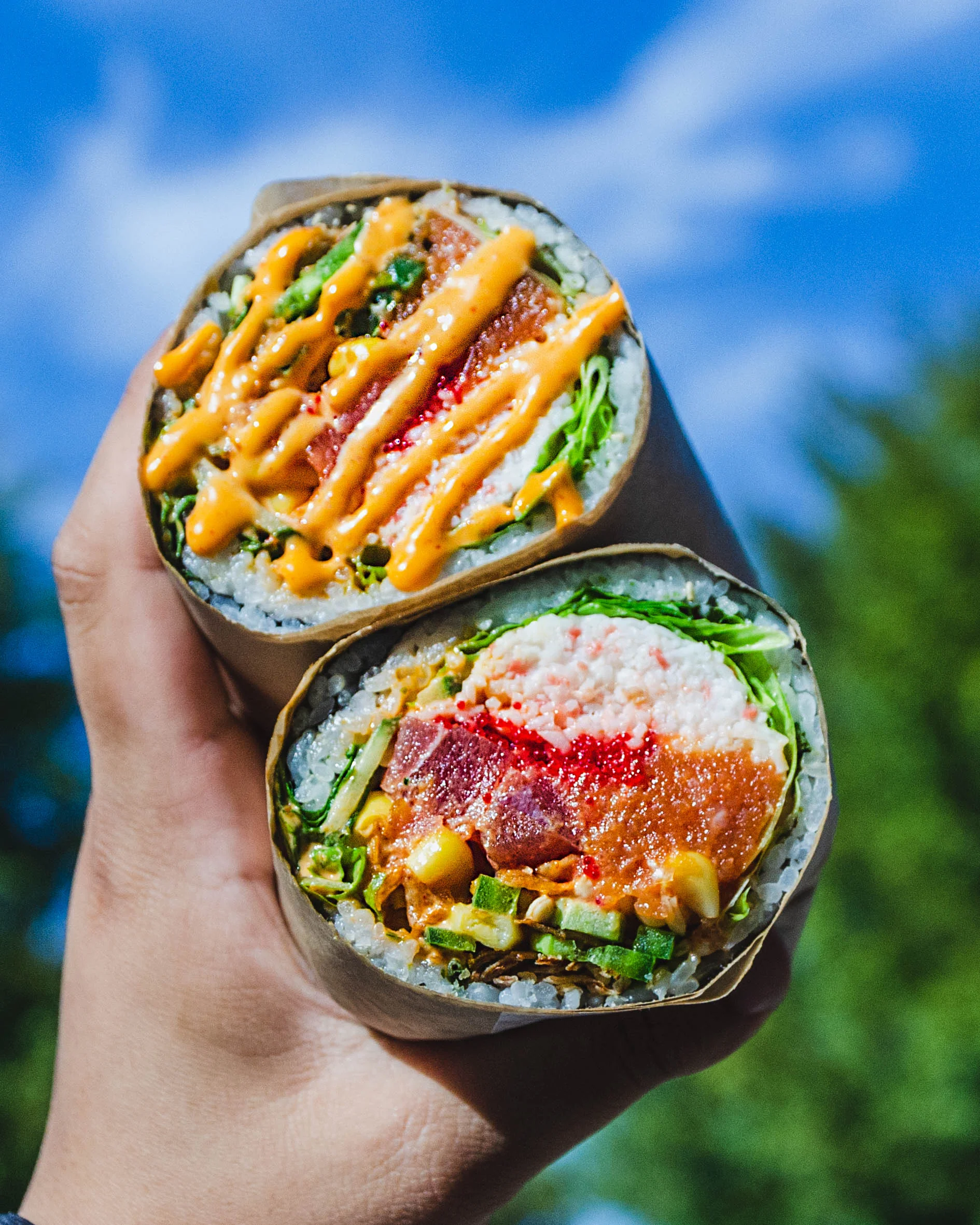 Four colorful poke bowls with various toppings and ingredients.