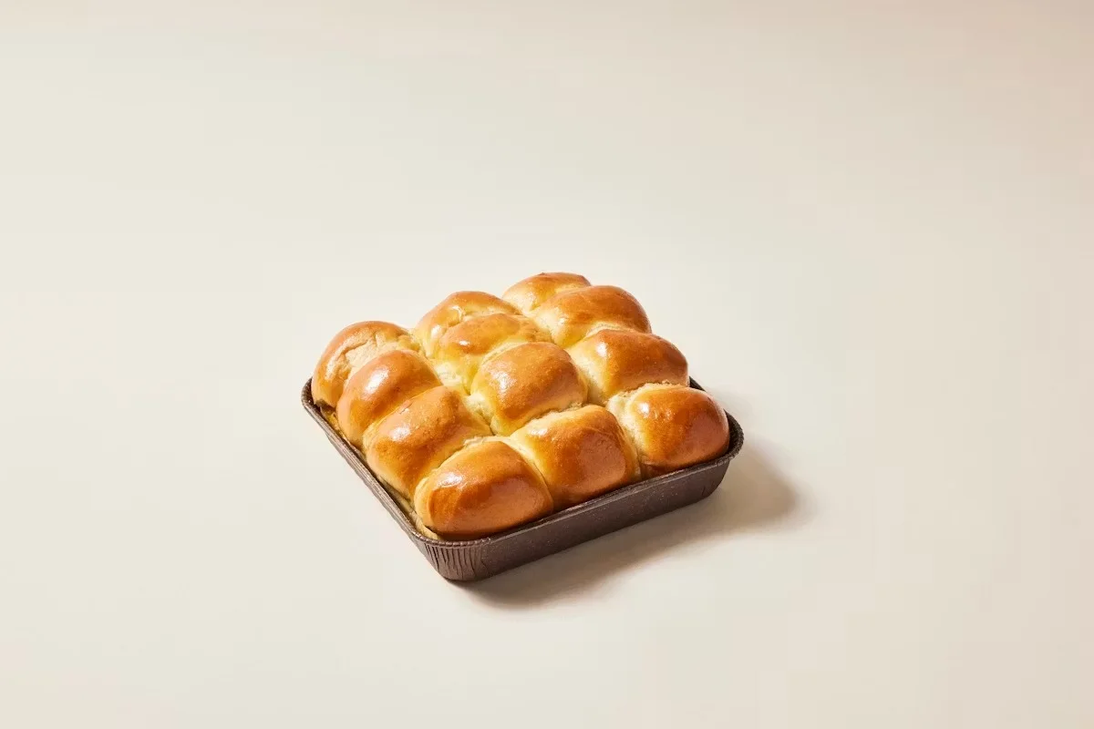 Freshly baked dinner rolls in a square pan