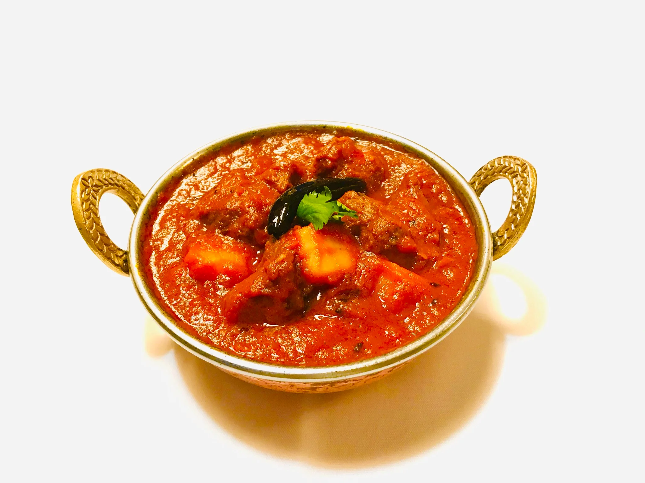 Rich Indian lamb curry served in a traditional bowl