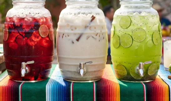 Colorful aguas frescas in glass dispensers