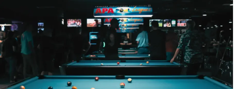Busy pool hall with players and illuminated tables